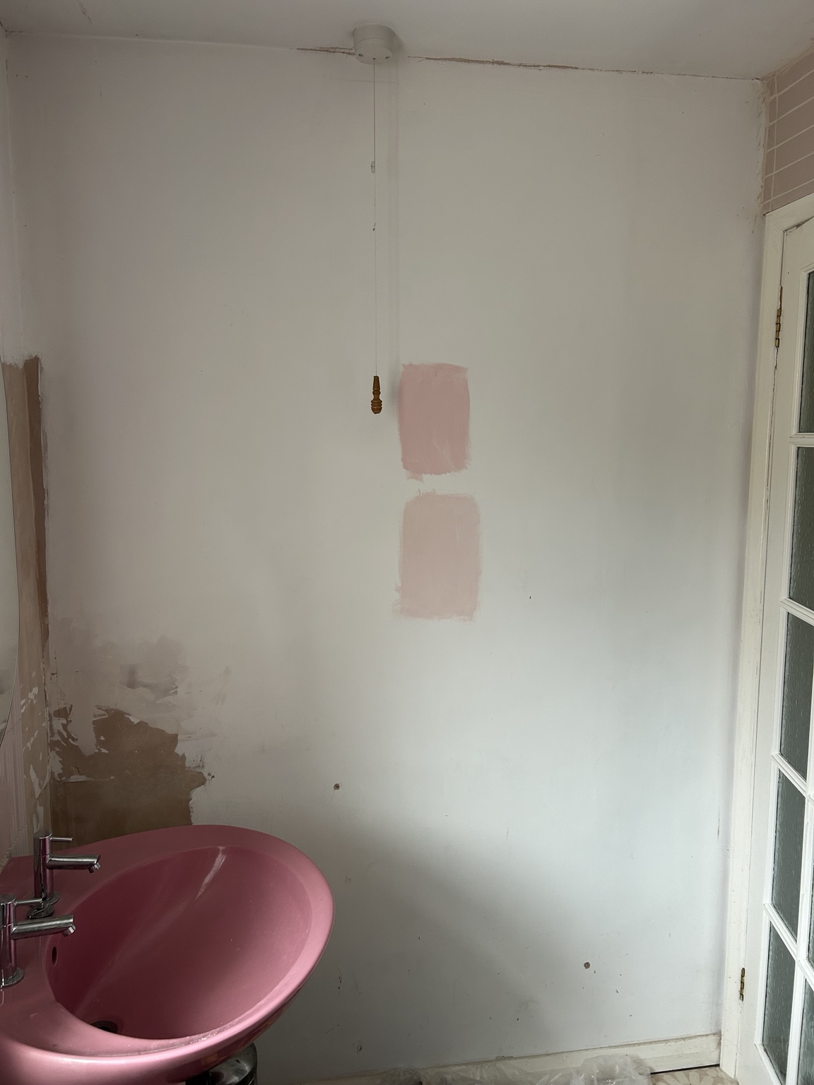 As we found it: patched, unpainted walls around the original basin